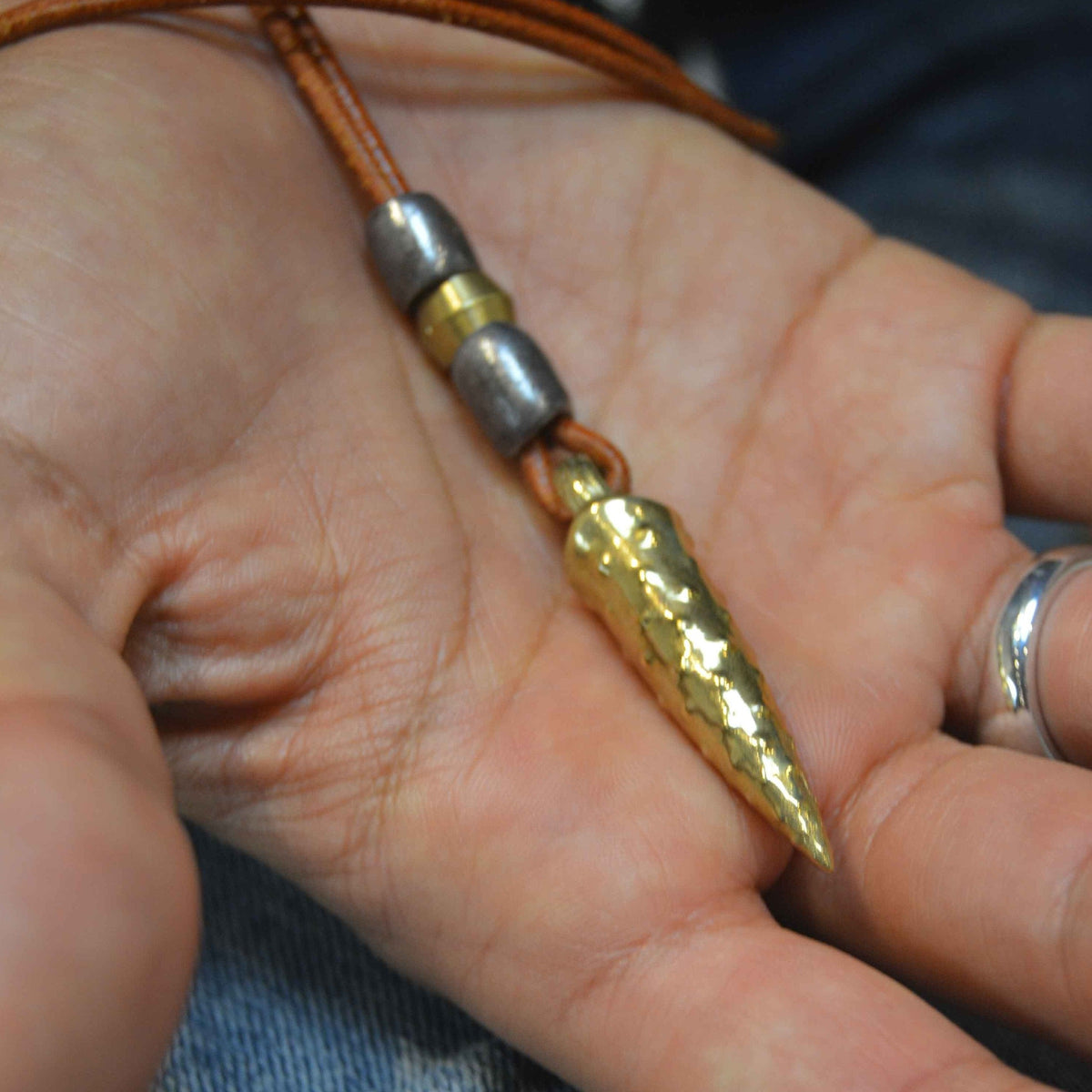 Bronze bullet pendant with a tribal look | organic bronze 