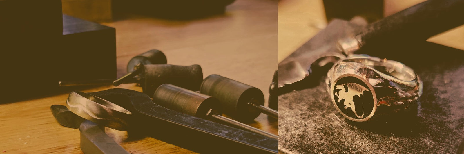 A close-up of a carved ring with a round stone, shown alongside metalworking tools on a wooden surface in a warm, moody setting.