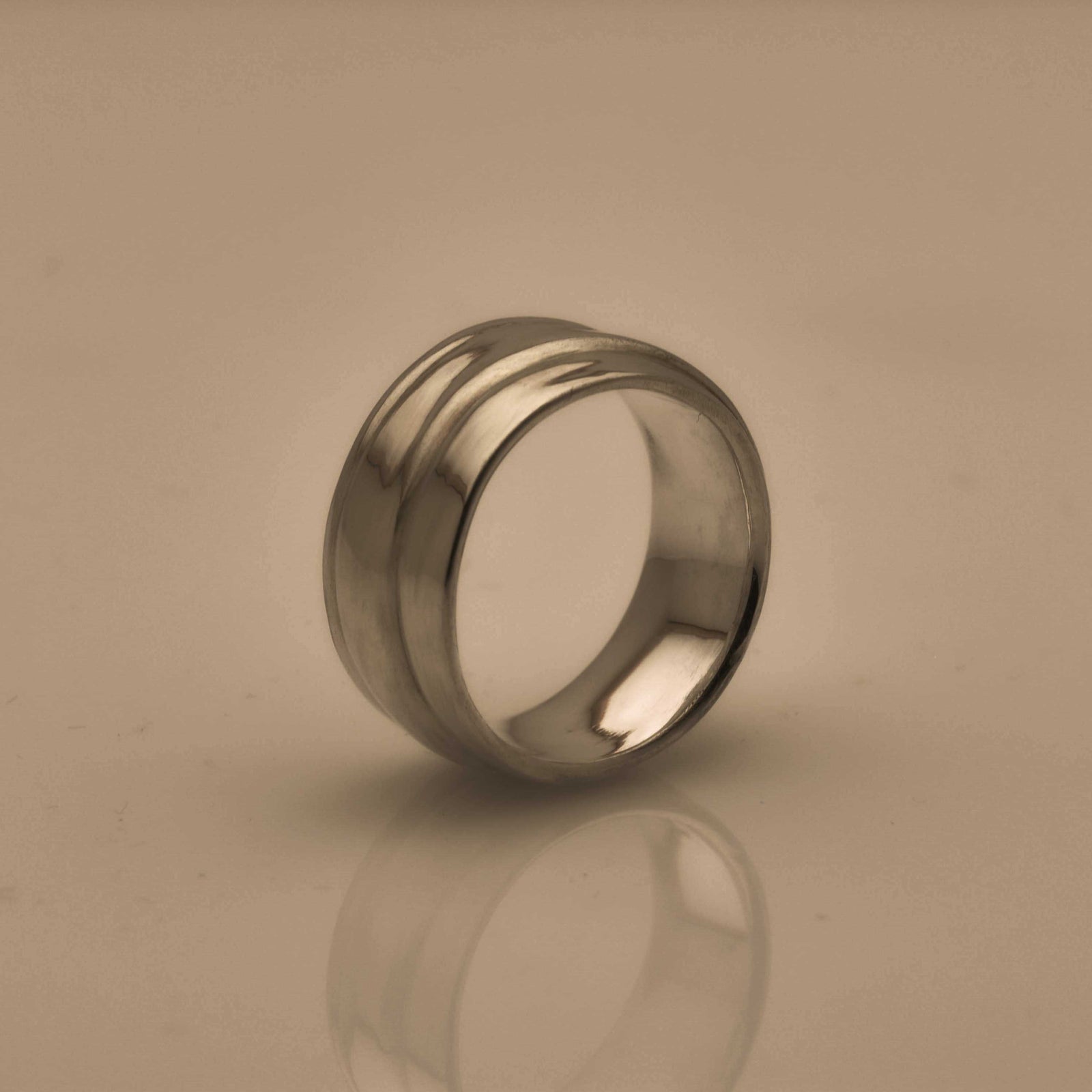 polished silver ring with a wave pattern 