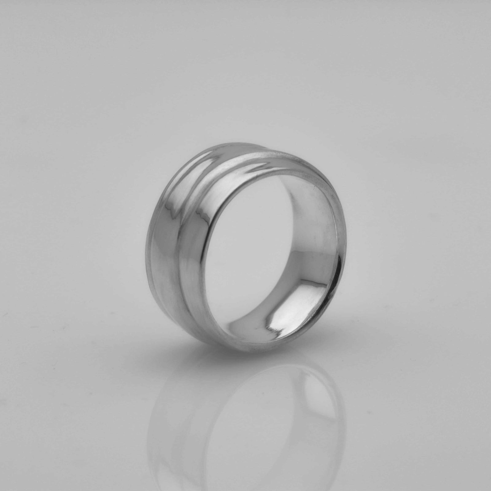 polished silver ring with a wave pattern 