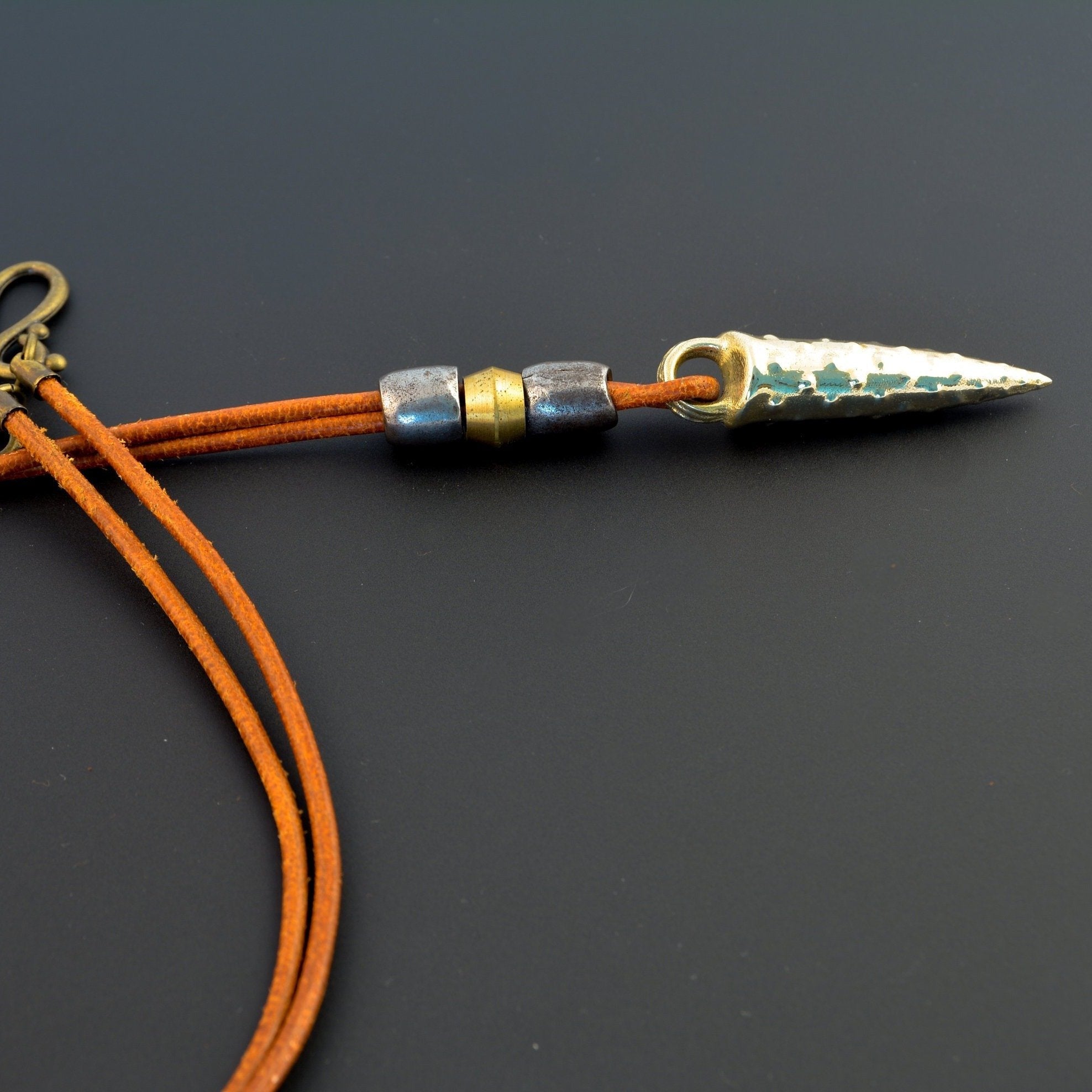 Bronze bullet pendant with a tribal look | organic bronze 