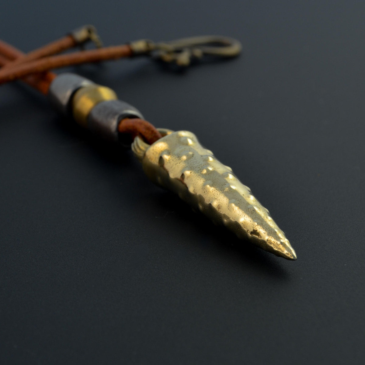 Bronze bullet pendant with a tribal look | organic bronze 