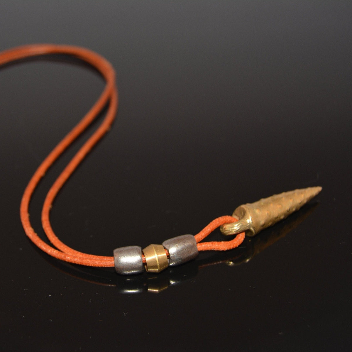 Bronze bullet pendant with a tribal look | organic bronze 