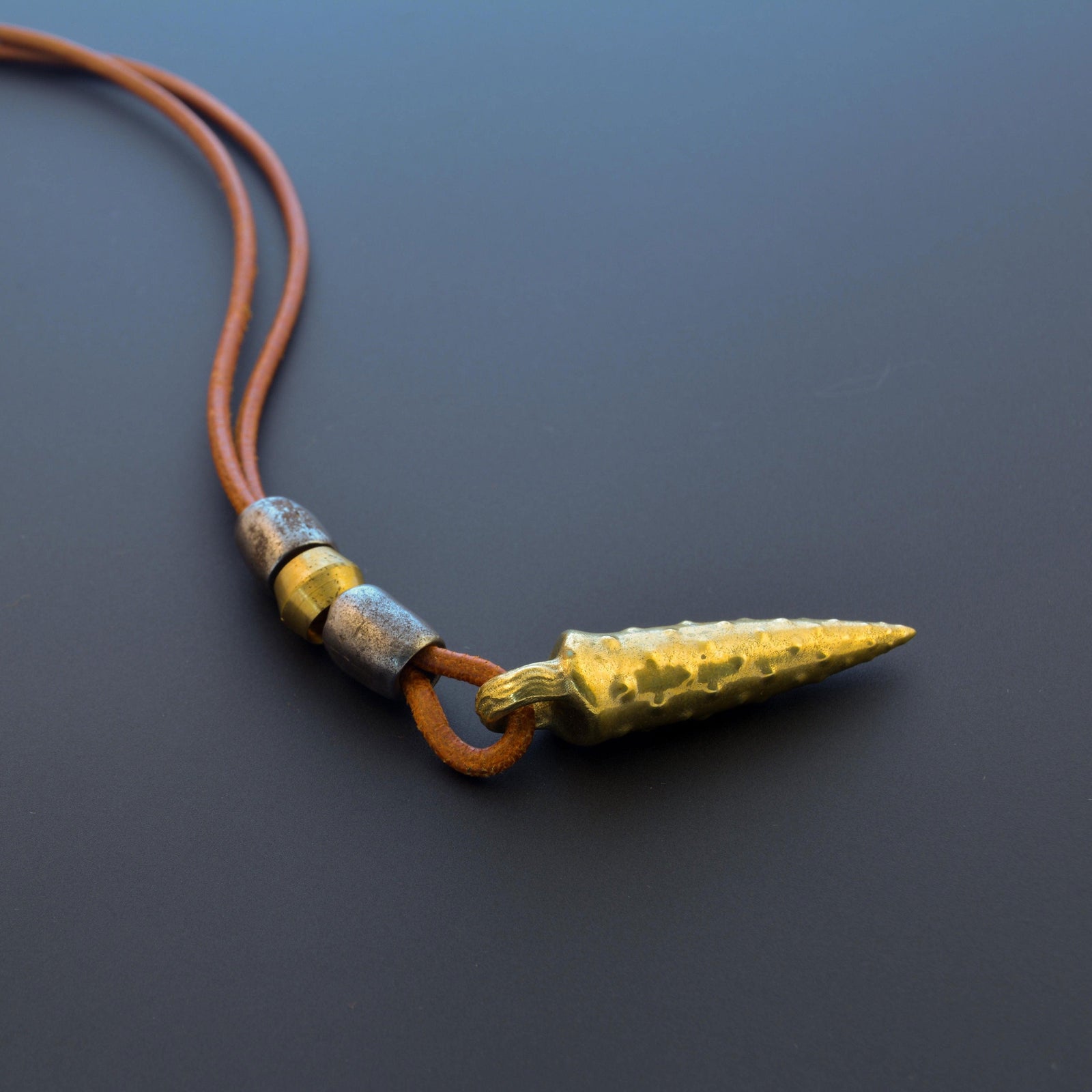 Bronze bullet pendant with a tribal look | organic bronze 