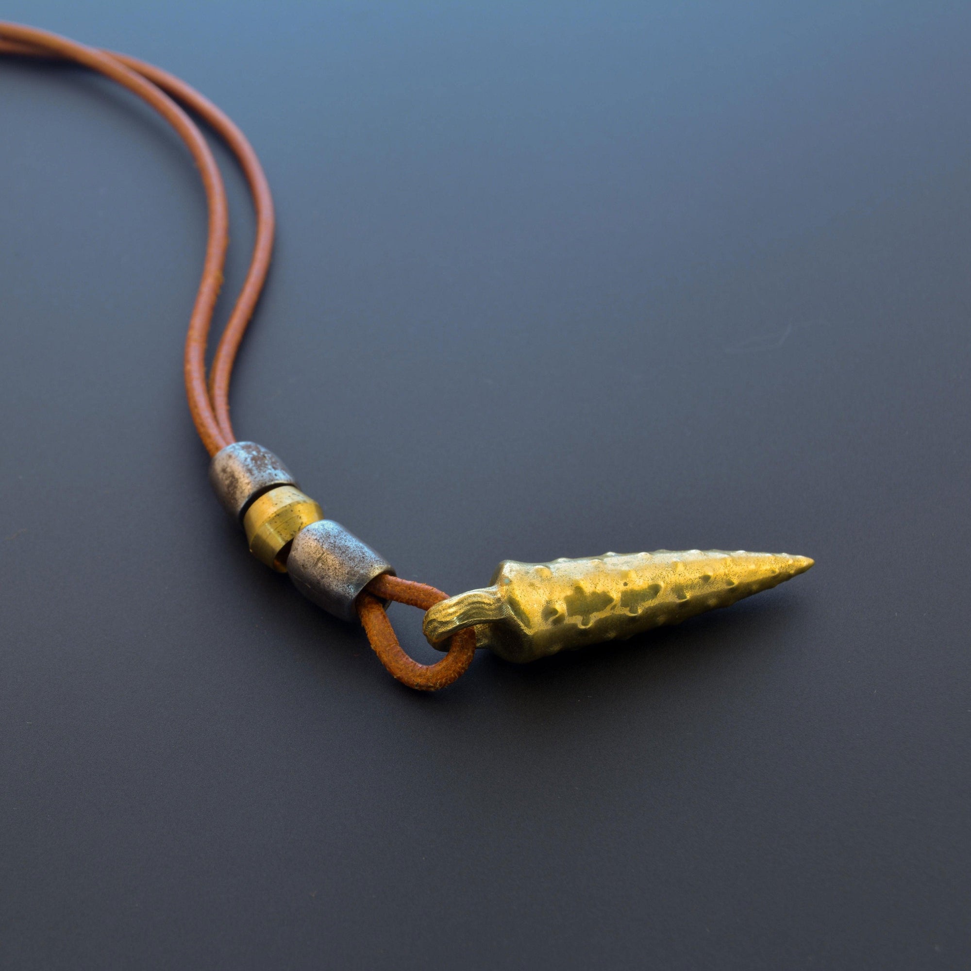 Bronze bullet pendant with a tribal look | organic bronze 