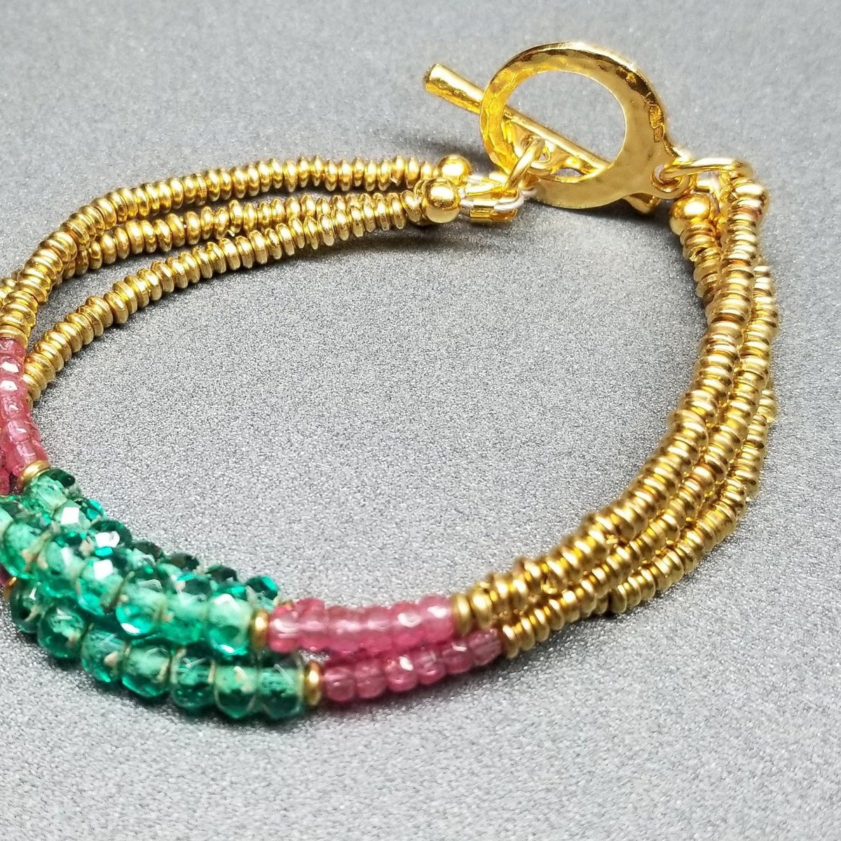 Pink and green gold triple strand bracelet
