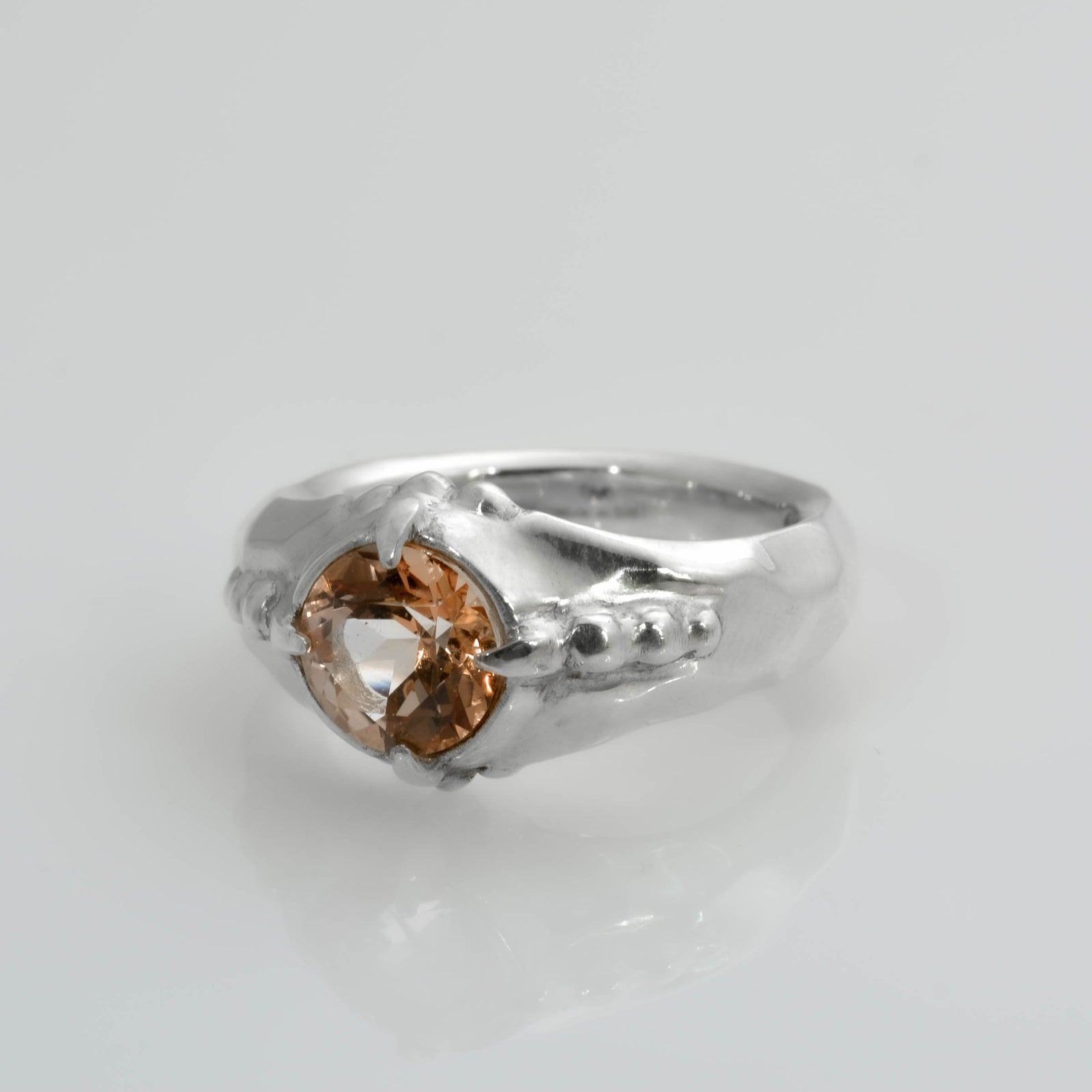 "Organic Elegance: Handcrafted Silver Ring with Exquisite Carvings and Orange Topaz" - Nine Amulets 