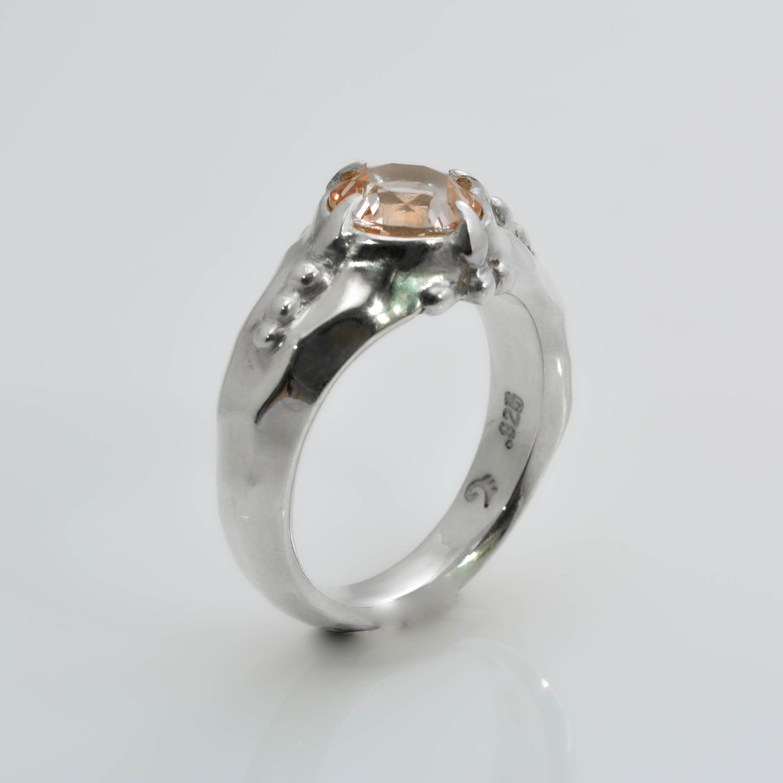 "Organic Elegance: Handcrafted Silver Ring with Exquisite Carvings and Orange Topaz" - Nine Amulets 