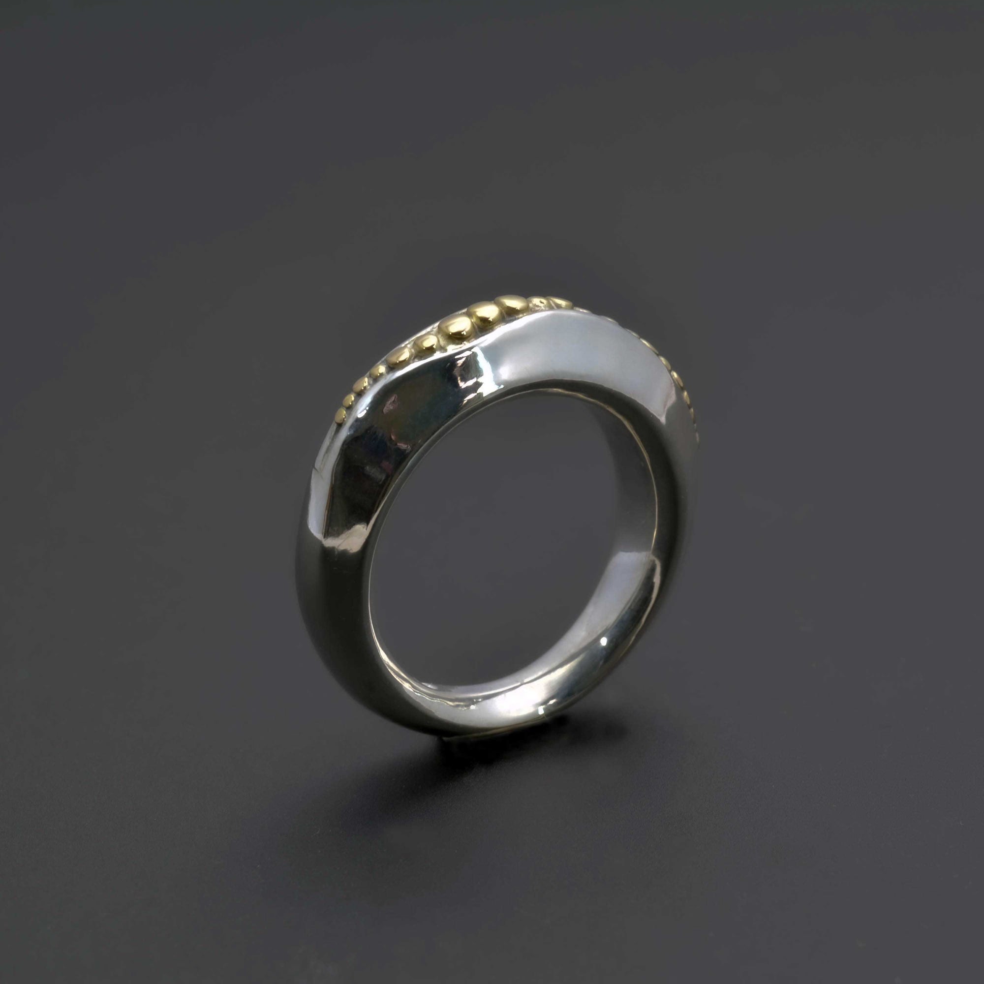 "Golden Spheres: A Unique and Elegant Sterling Silver Ring with 14K Gold Accents" - Nine Amulets 