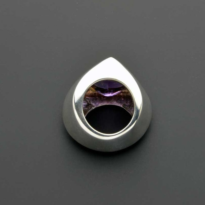 side view of triangular dome ring with amethyst