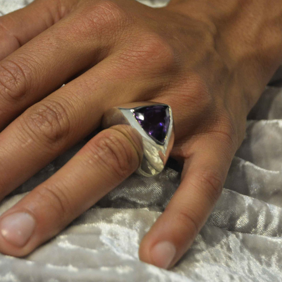 Wearing a triangular amethyst ring