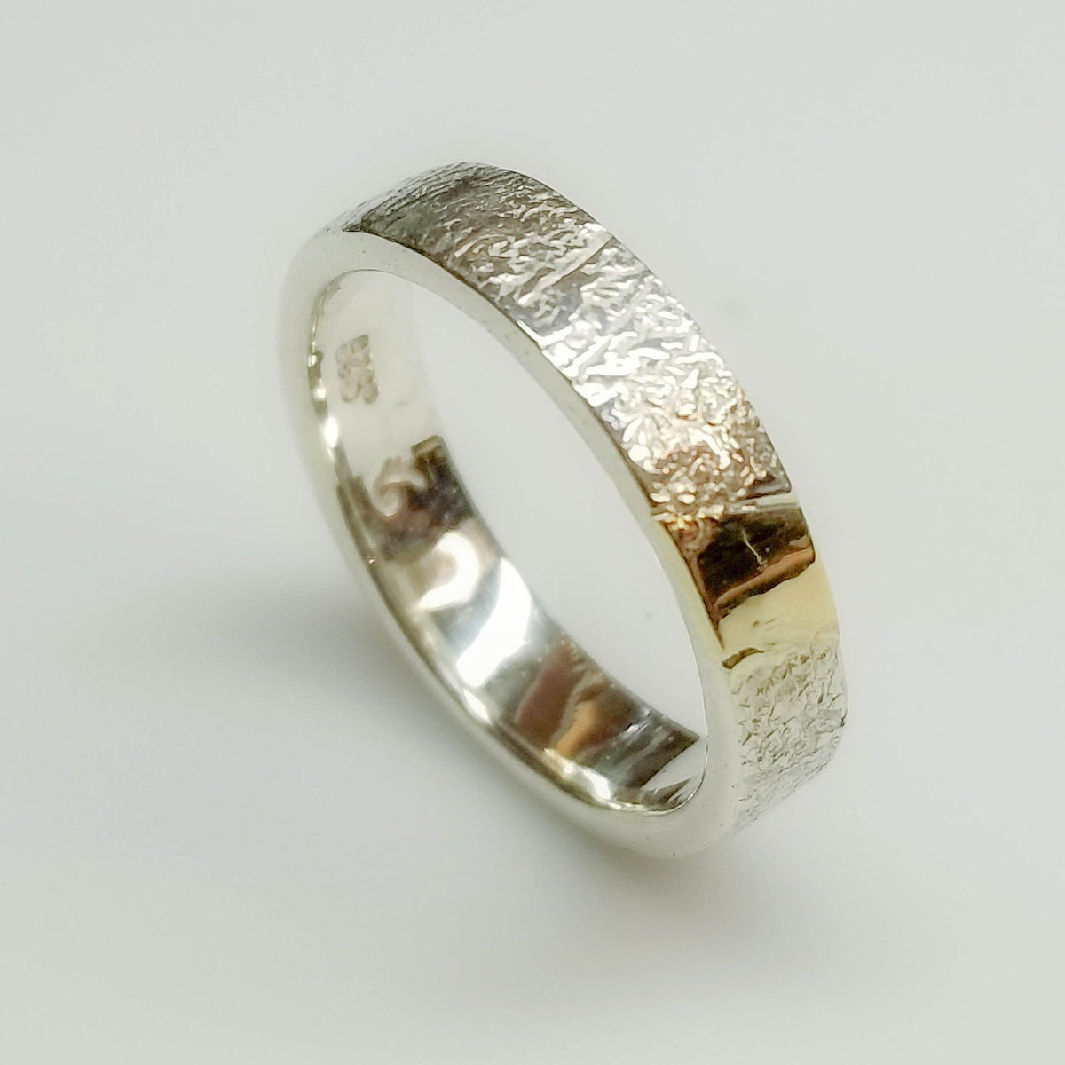 Textured silver with gold inlay band