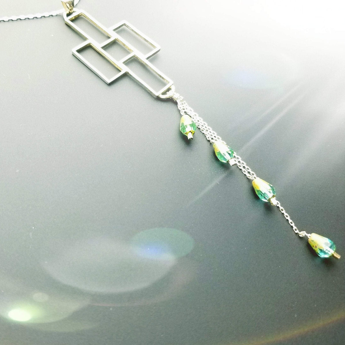 Crosses with dangling emerald color crystal beads