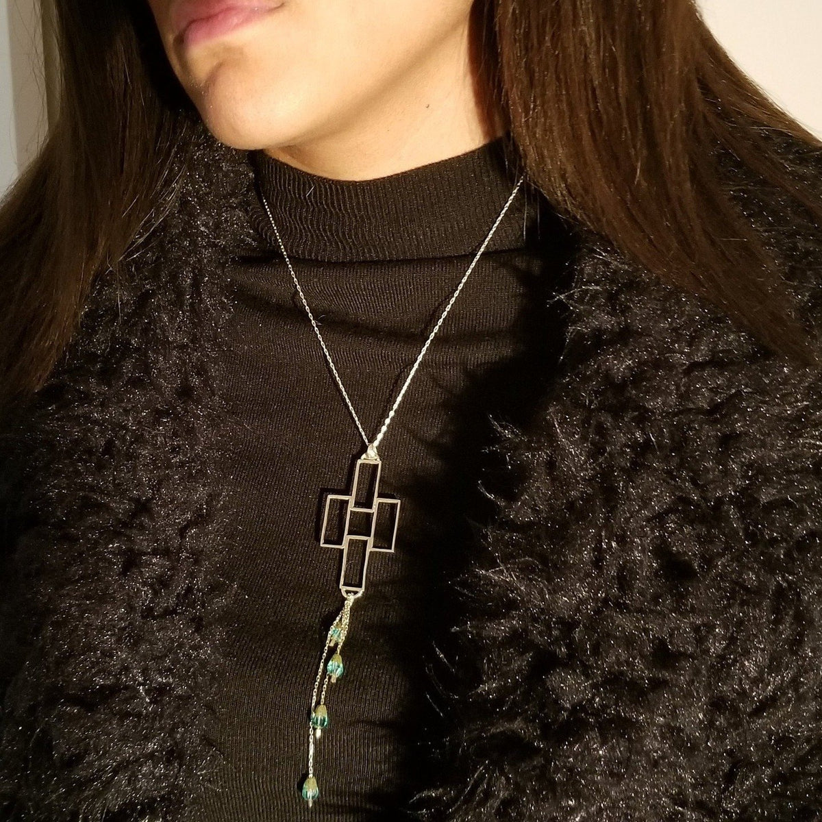 Silver chain necklace with rectangular pendant and emeralds
