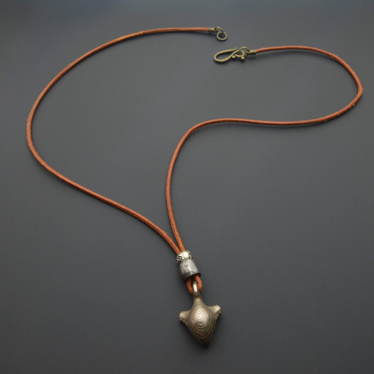 Iron earth pendant and orange cord